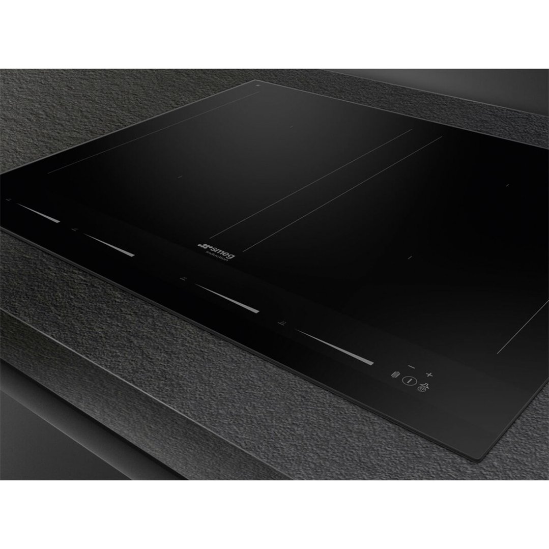 Black induction cooktop with controls on a dark grey textured countertop