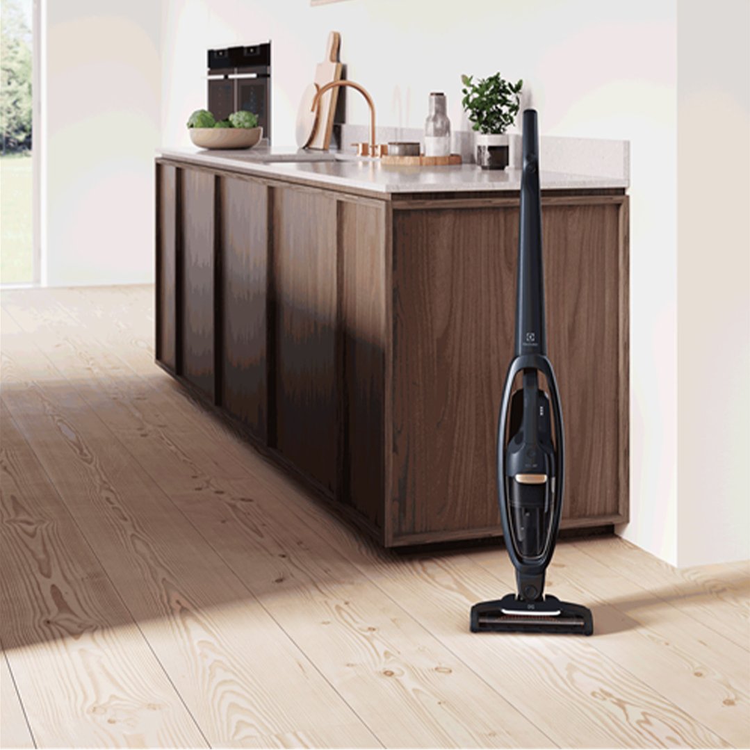 Electrolux Well Q7 Cordless Vacuum standing on a wooden floor in a modern kitchen