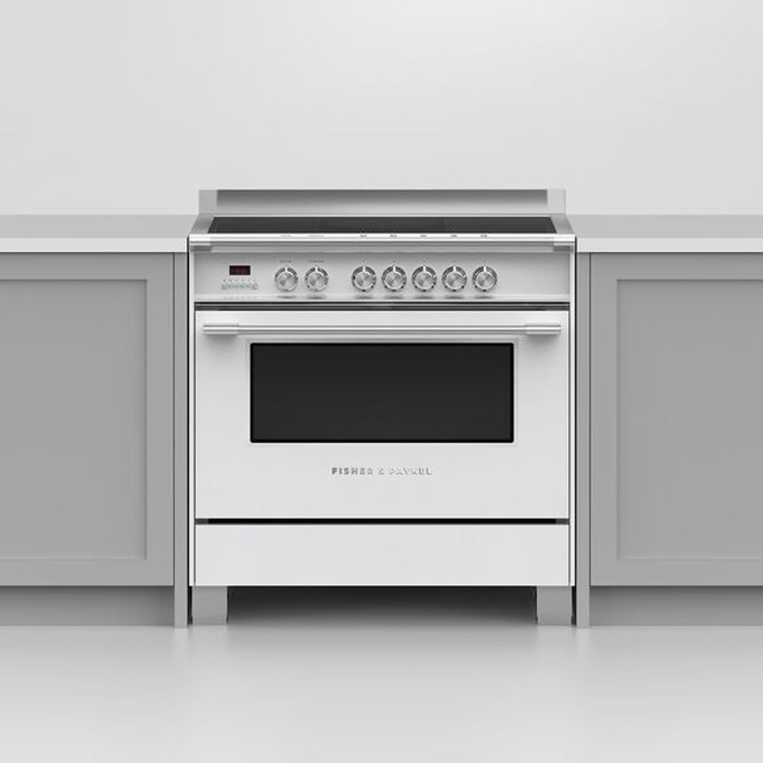 White Fisher & Paykel induction cooker installed between grey kitchen cabinets