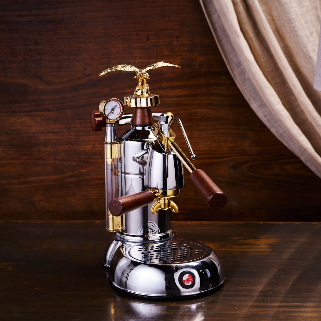 La Pavoni coffee machine with gold eagle on a dark wooden surface