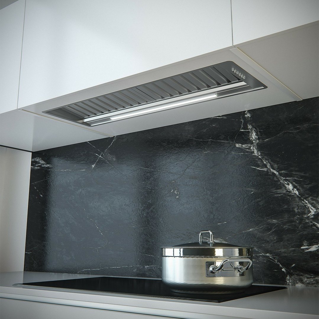 Undermount rangehood installed above a cooktop with a pot in a modern kitchen