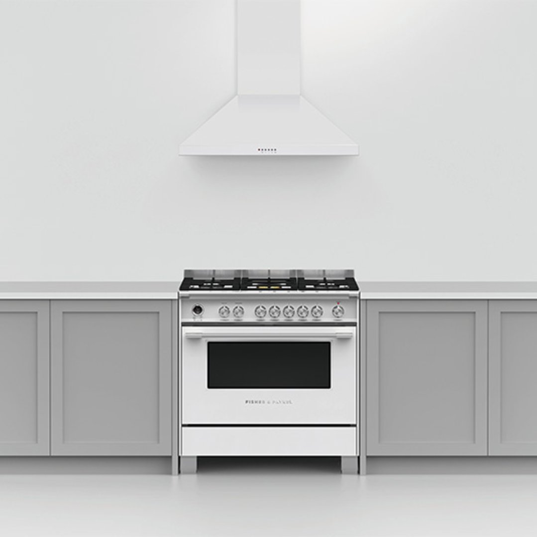 White dual fuel pyrolytic cooker in a kitchen with light grey cabinets