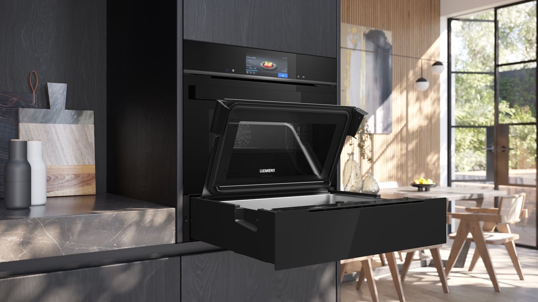 Black Siemens iQ700 steam drawer and oven in a modern kitchen