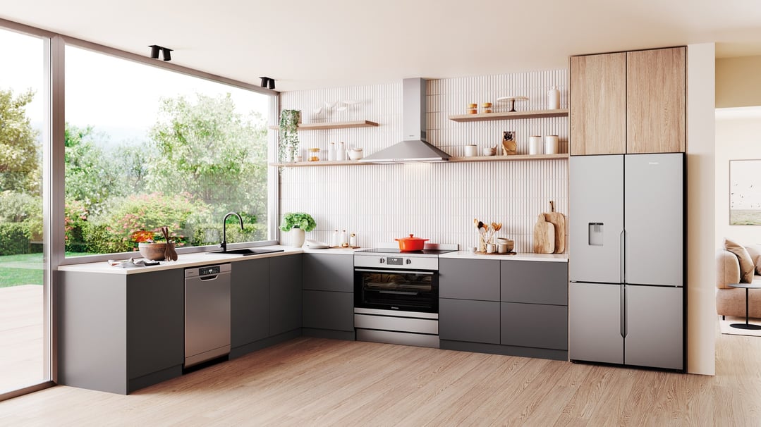 Freestanding oven in a modern kitchen with grey cabinets and large window