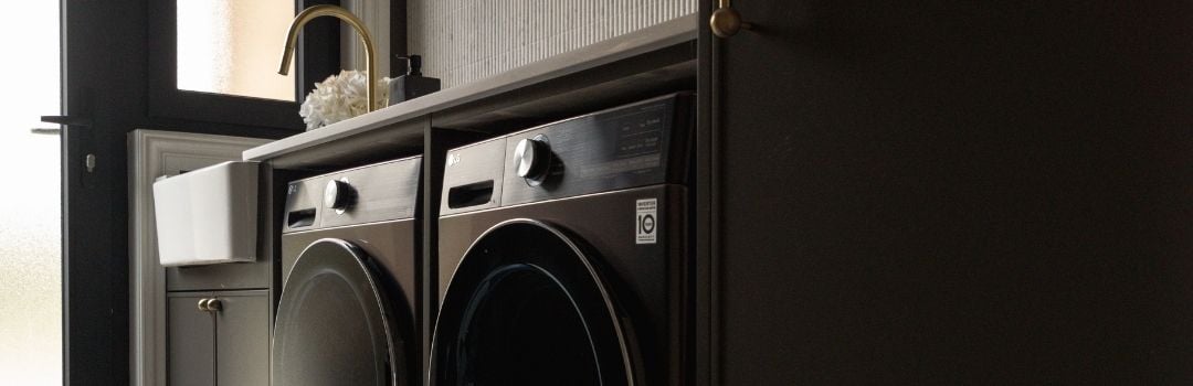 An aesthetic black laundry featuring an LG washer and dryer side by side.